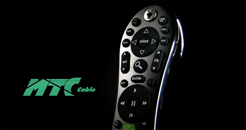 A remote control is featured in dramatic light against a black background.